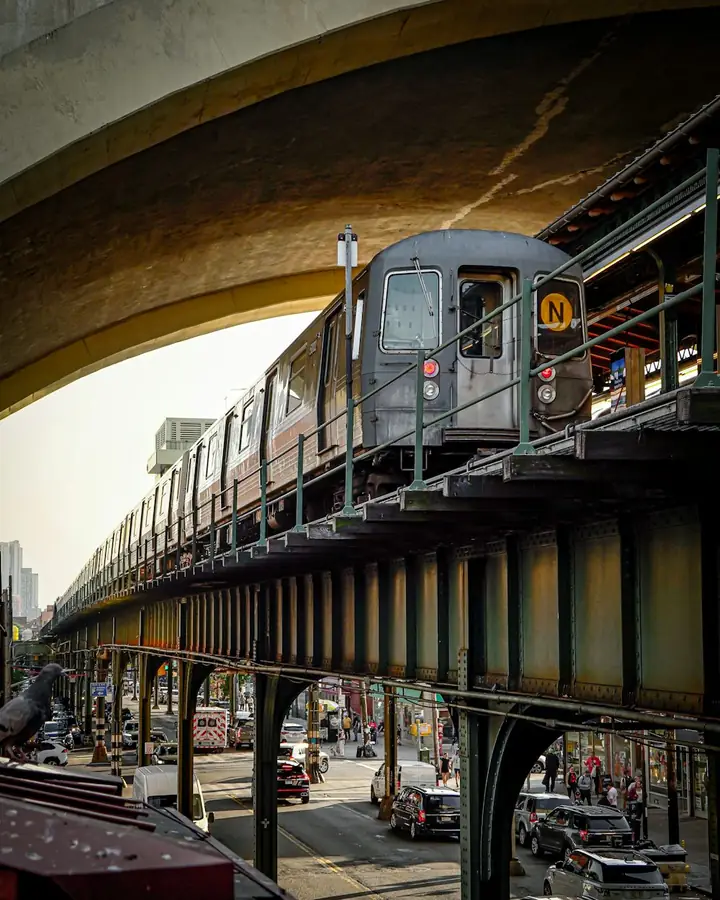 Elevated subway train on a steel structure above a city street