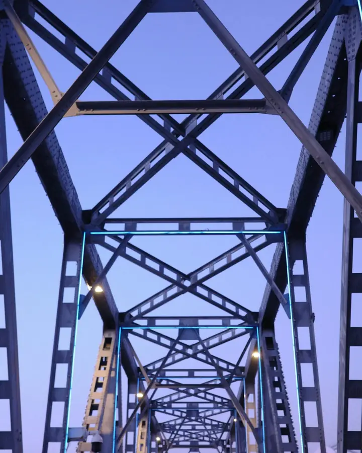 Looking up through the steel trusses of a bridge